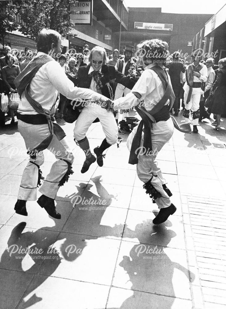 members of Derby, Doncaster and Bangor morris dance teams, dancing in Albert Square.