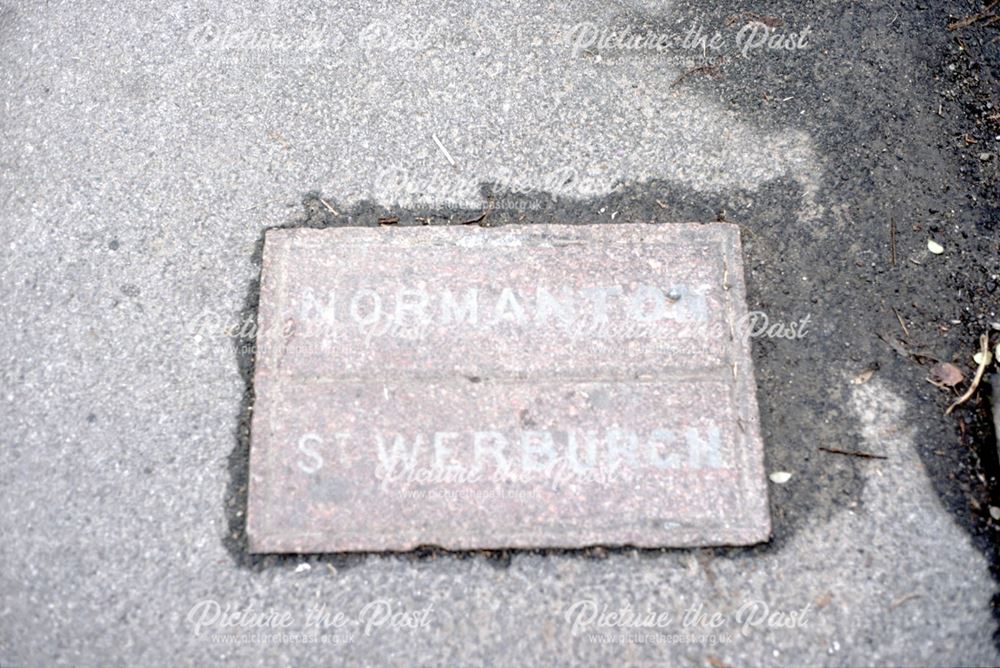 Parish boundary marker set into the pavement