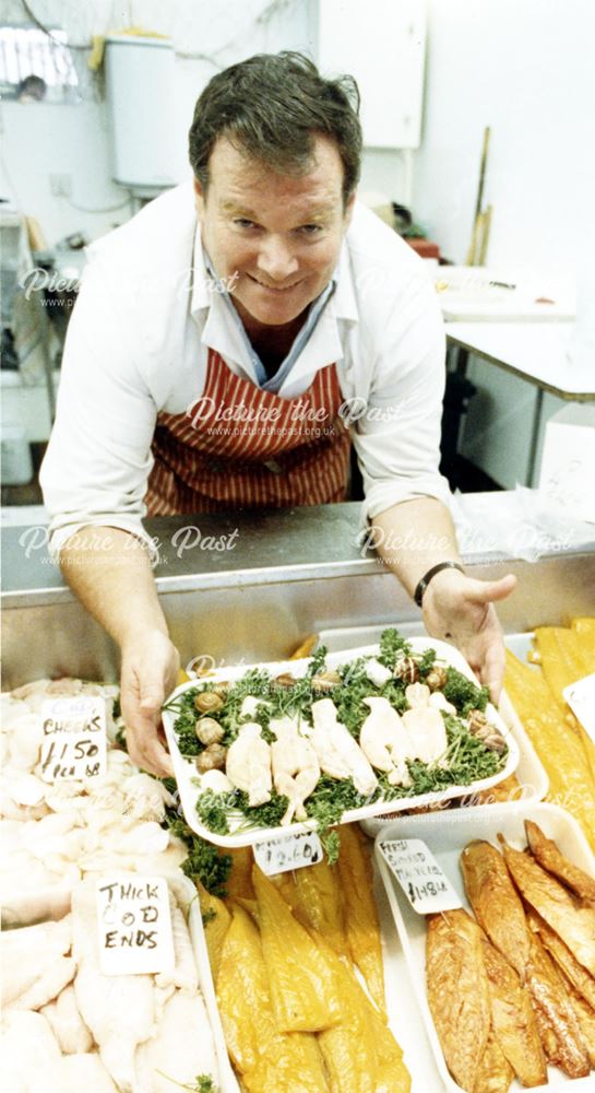 Fishmonger displaying his goods, Derby Fish Market