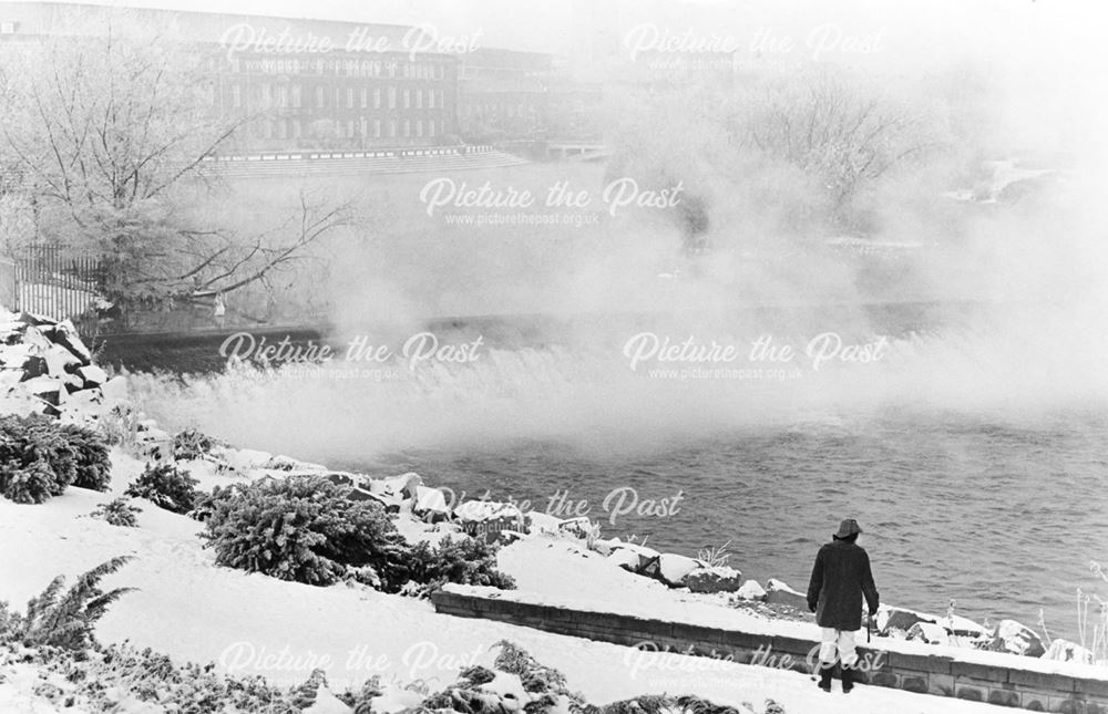 Steam rising from the River Derwent weir next to the River Gardens, in winter