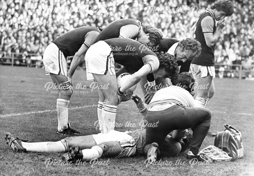 Aston Villa goalkeeper Jimmy Rimmer recovers from a knock