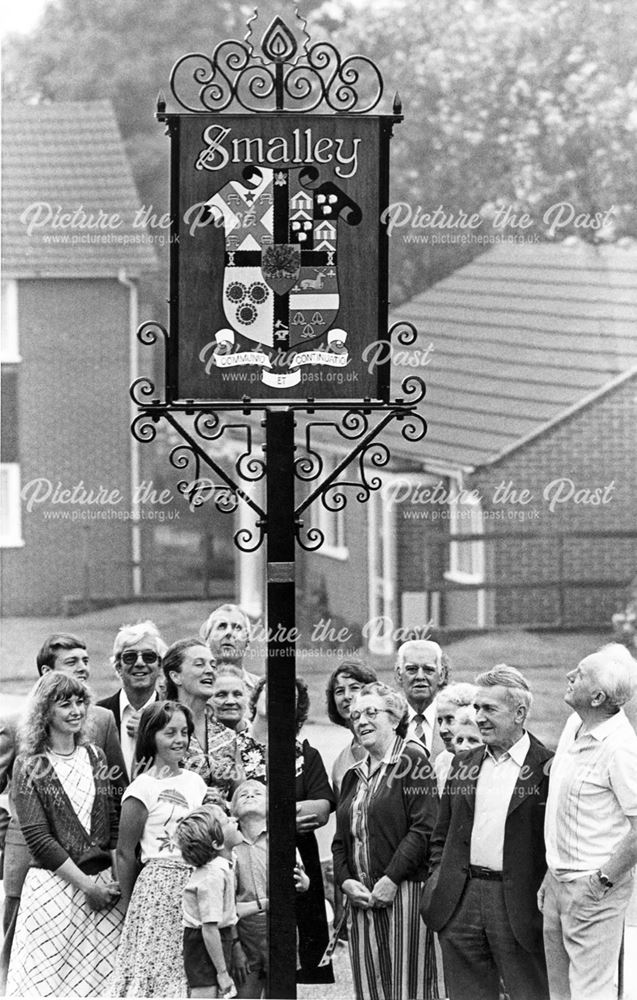 Local residents gathered around the village signpost, Smalley
