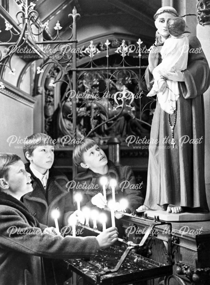 St Mary's RC Church - Children light candles at midnight mass to celebrate the new year