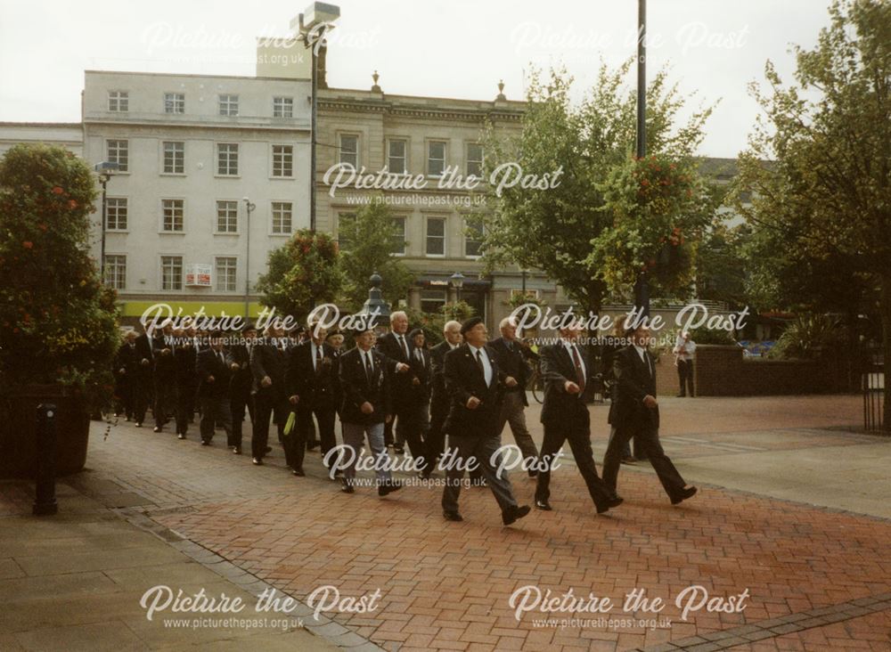 Former Worcestershire and Sherwood Foresters marching past the war memorial