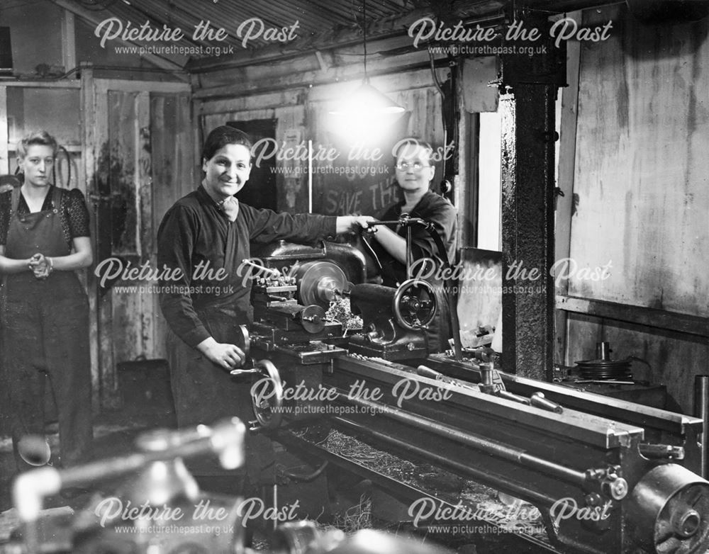 Women metal workers, machine centre lathe turning, Derby, during World War 2