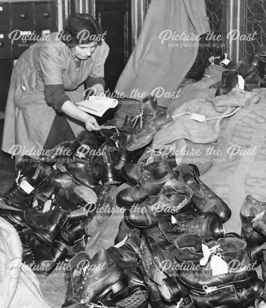 A woman worker, sorting boots, Derby, during World War 2