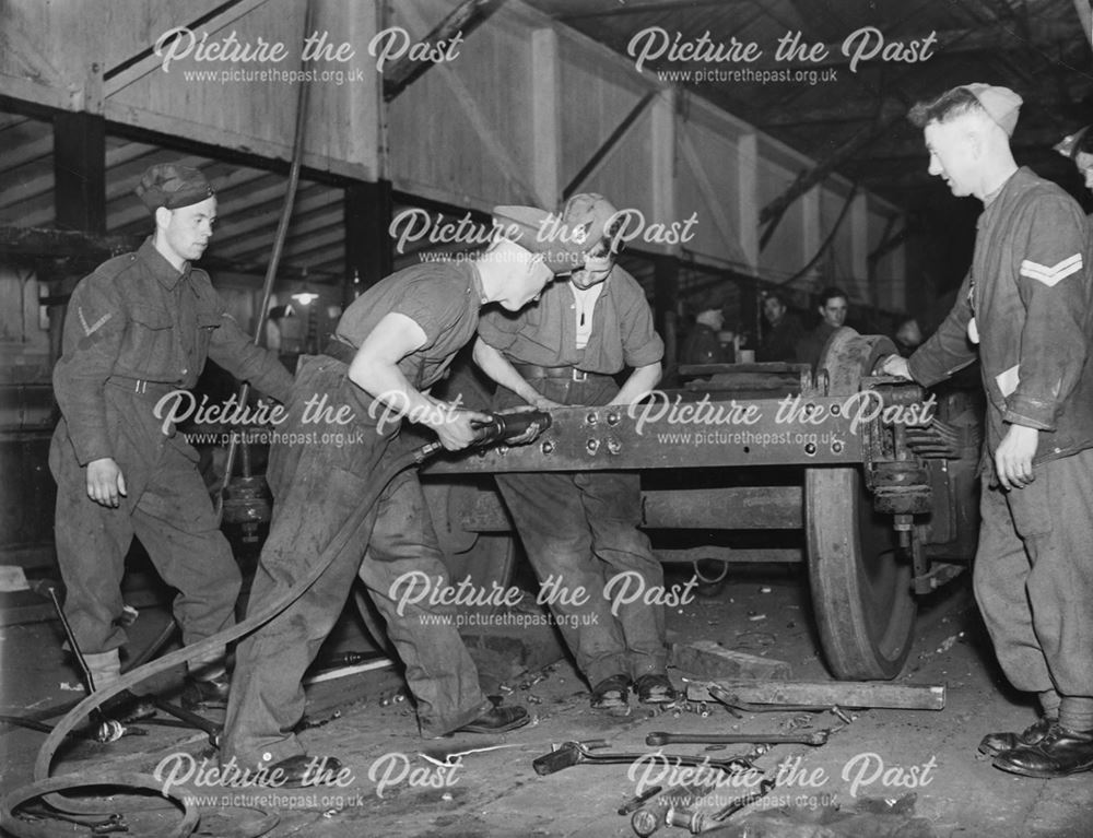 Men of the Royal Engineers working on a railway wagon chassis, Derby, during World War 2