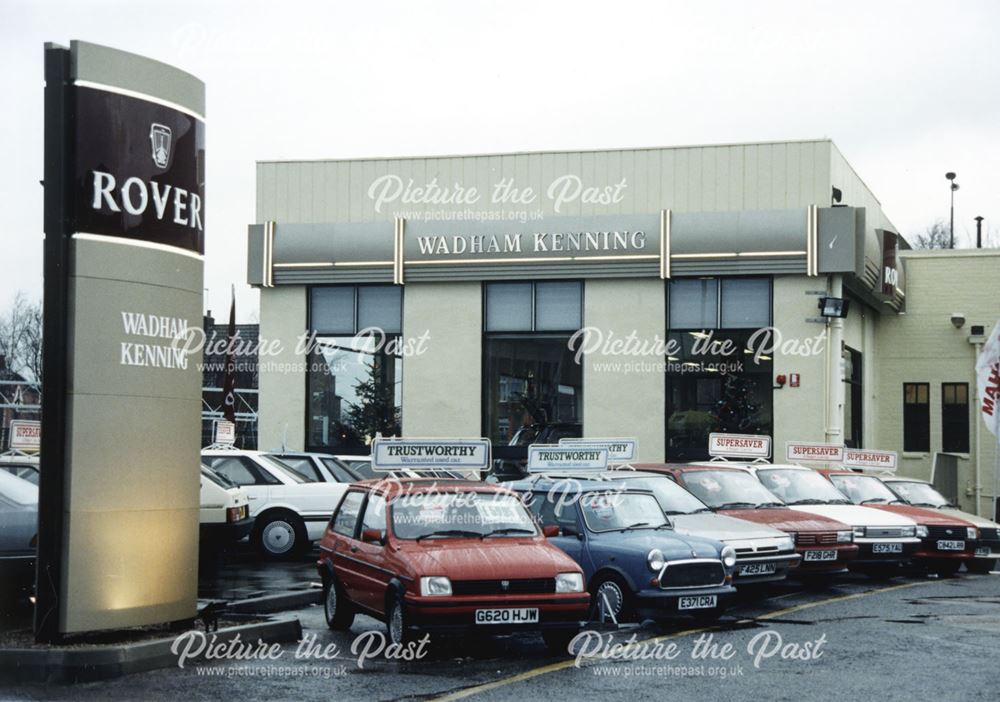 Wadham Kenning' car show room, with cars on the forecourt