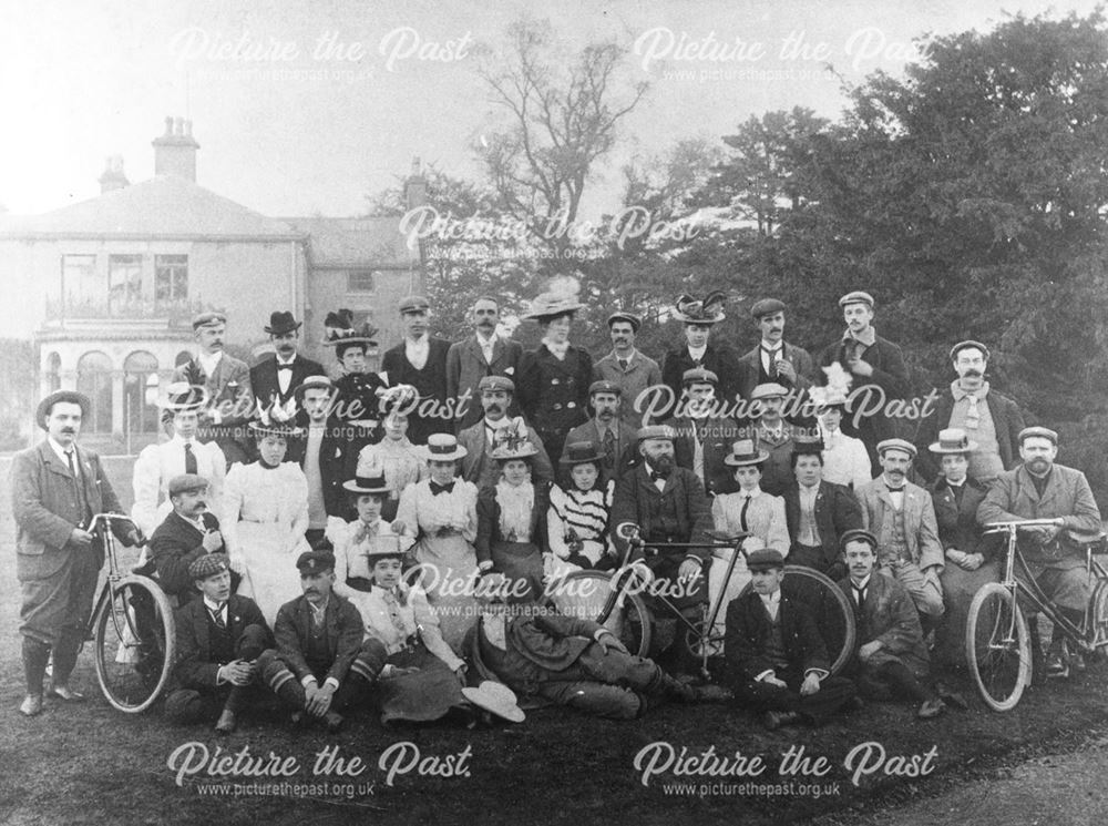 Group photographed outside large house