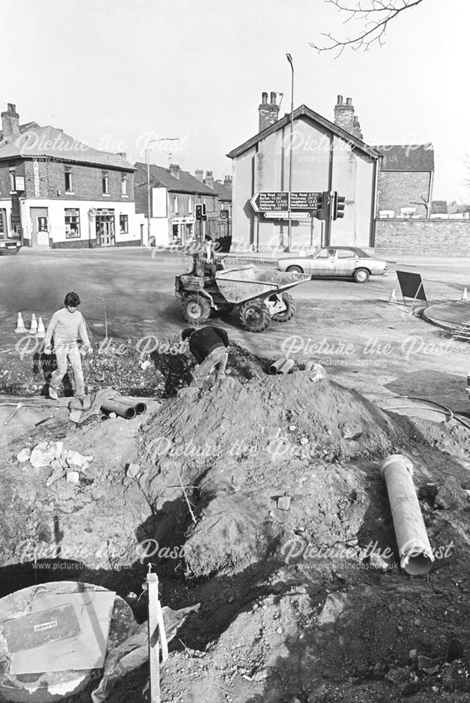 View showing pipes being laid at the junction of Sinfin Lane and Osmaston Park Road