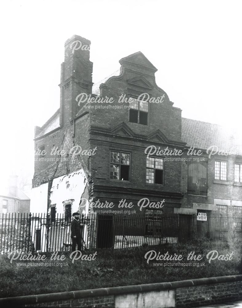 Exterior of Queen Anne House, in the process of demolition