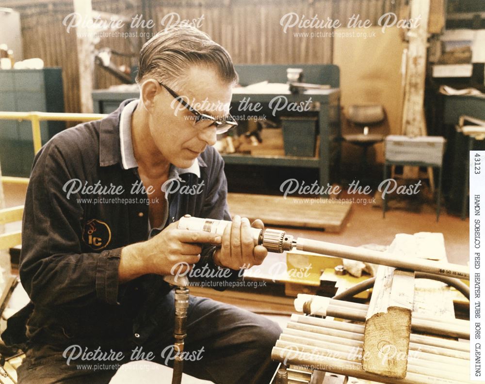 International Combustion Limited - An employee Cleaning the Hamon Sobelco Feed Heater Tube Bore 