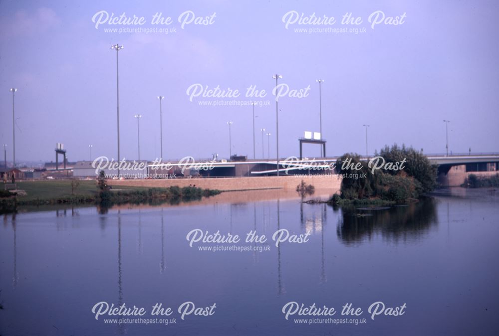 View across the River Derwent with a road bridge in the background