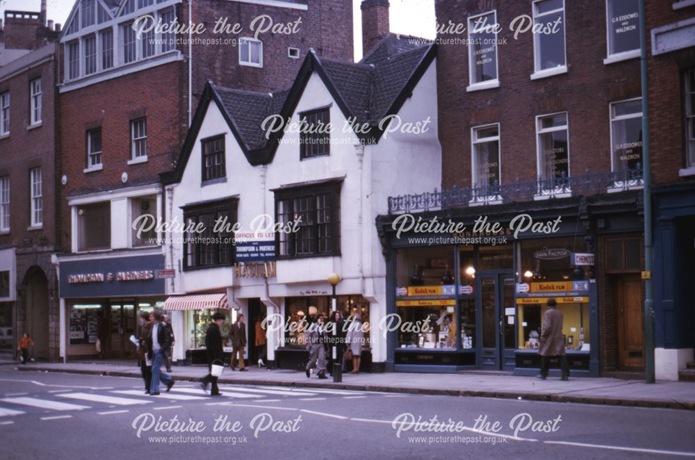 View along shops of Monkhouse Chemists and Thompson and Partners