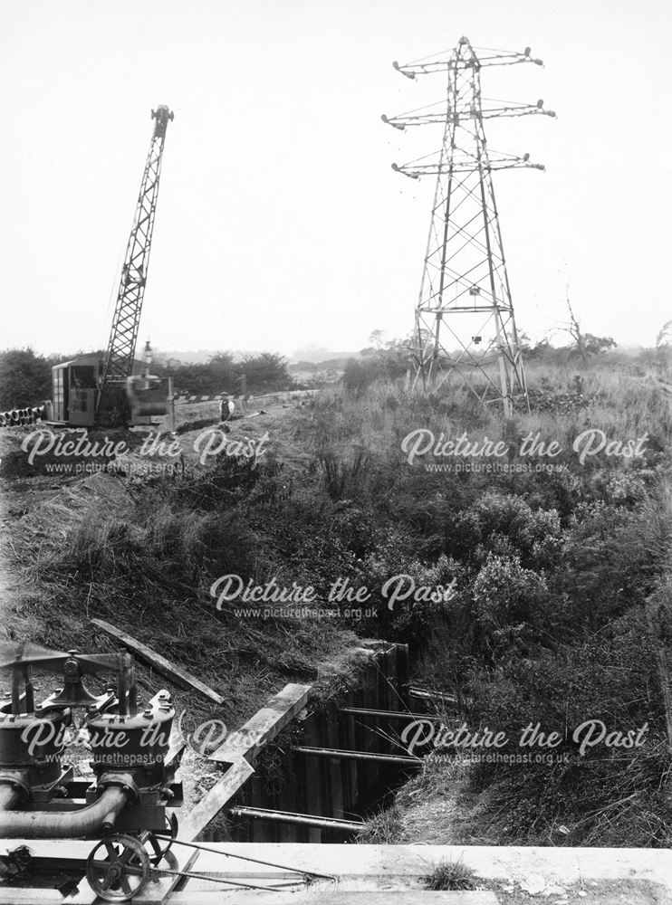 Excavator, excavating open channel at 'D' weir