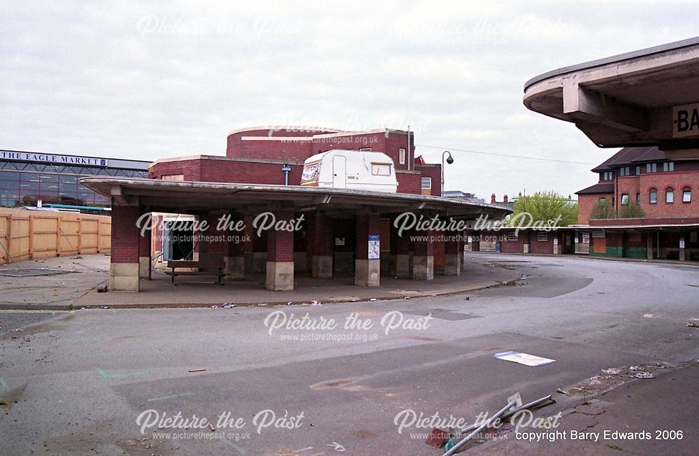 Disused bus station buildings with protester's caravan on roof 