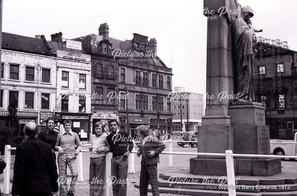 Market Place with local teenagers and war memorial 